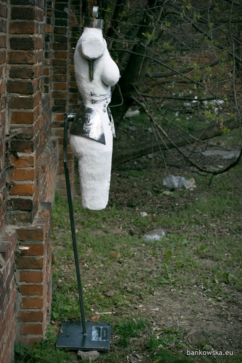 Contemporary sculpture blending organic form with mechanical structures, wires, and electronic components.
